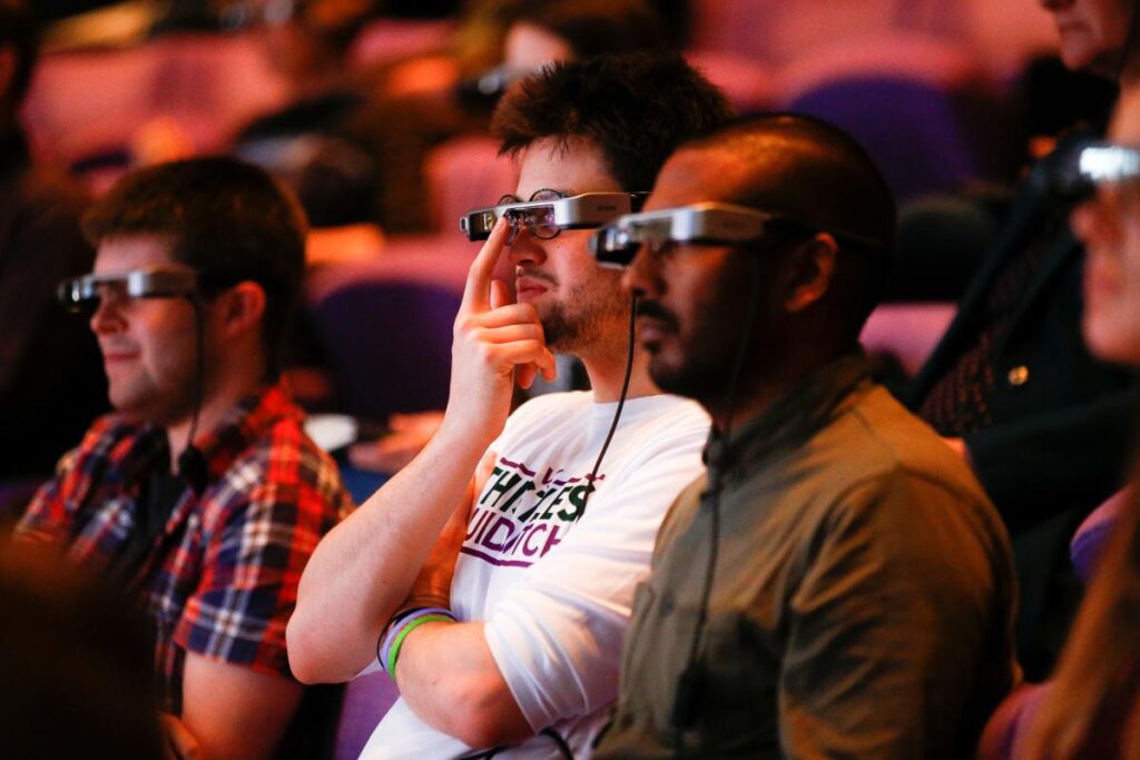 People watch a live performance of Exit the King at the National Theatre while wearing Smart Caption Glasses in London, Britain, October 3, 2018. REUTERS/Henry Nicholls